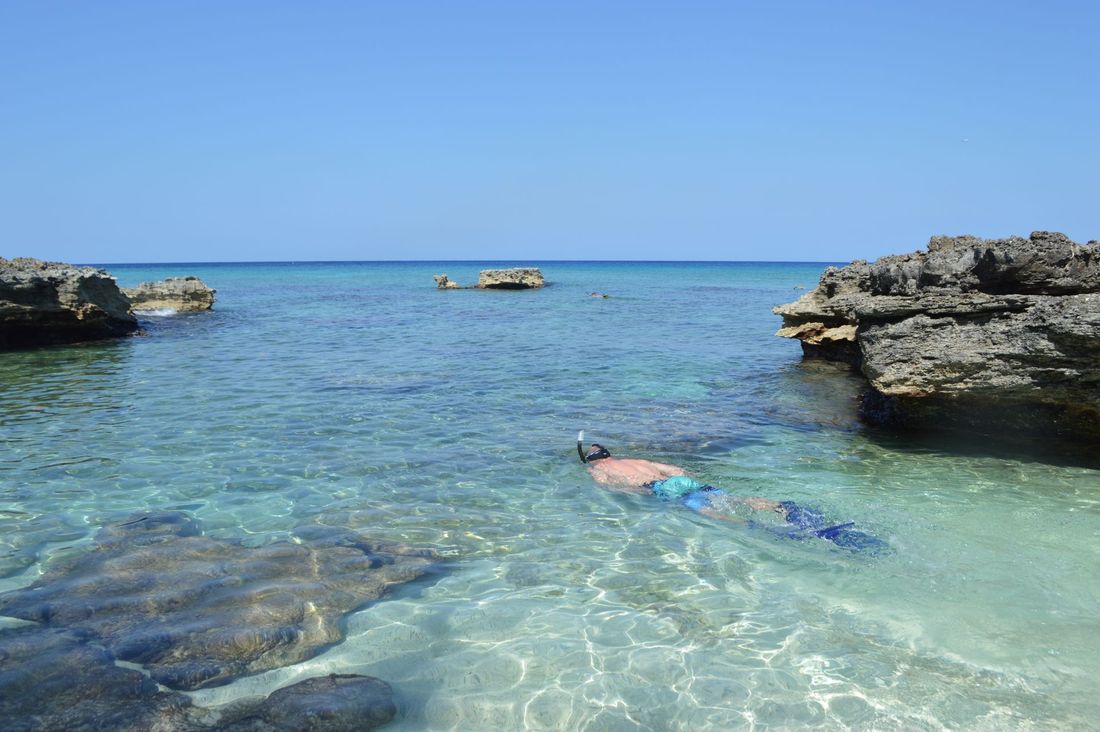 Snorkellers in clear water near Mnemba Atoll