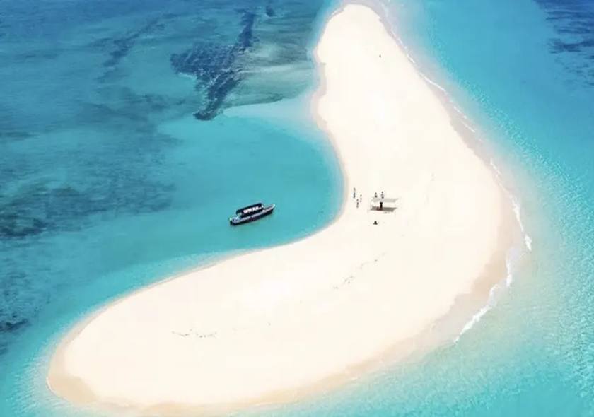 Boats moored at a white sandbank in the Indian Ocean